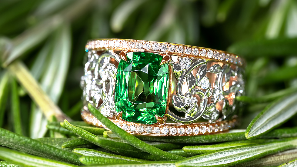 Hollow cut-out ring with vine motifs inspired by nature, adorned with deep forest green tsavorite garnet and milgrain detail in rose gold.