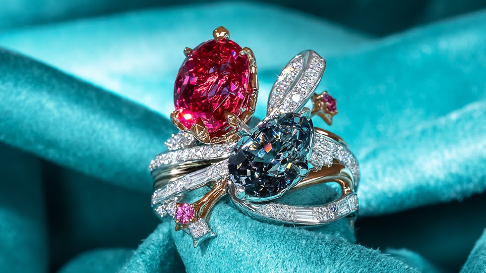 Stack ring featuring a combination of oval red spinel and pear-cut grey spinel, designed with a ribbon-like diamond pave band adorned with star motifs.